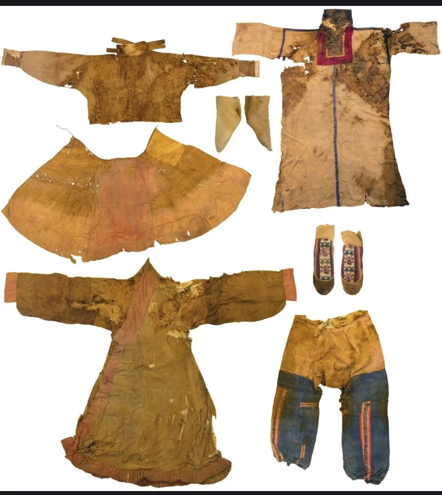 Complete set of excavated garments from the Niya archaeological site, including silk robes, skirts, woollen trousers, and embroidered socks from c. 60-130 CE